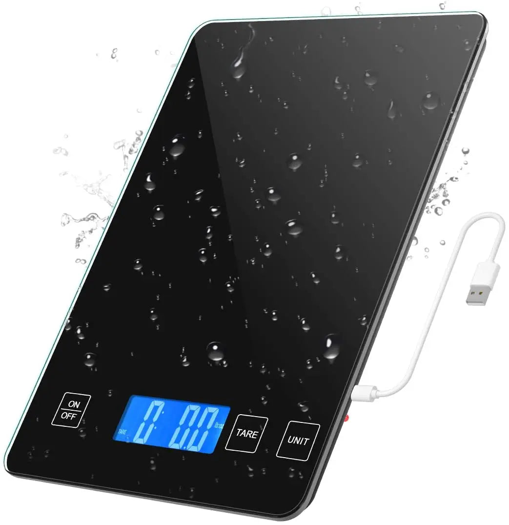 Digital kitchen scale with water droplets on the surface and a USB cable.