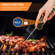 Thermometer probe inserted into a steak on a grill with text about the 'Hold' function.