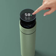 Green thermos with digital temperature display on a green background