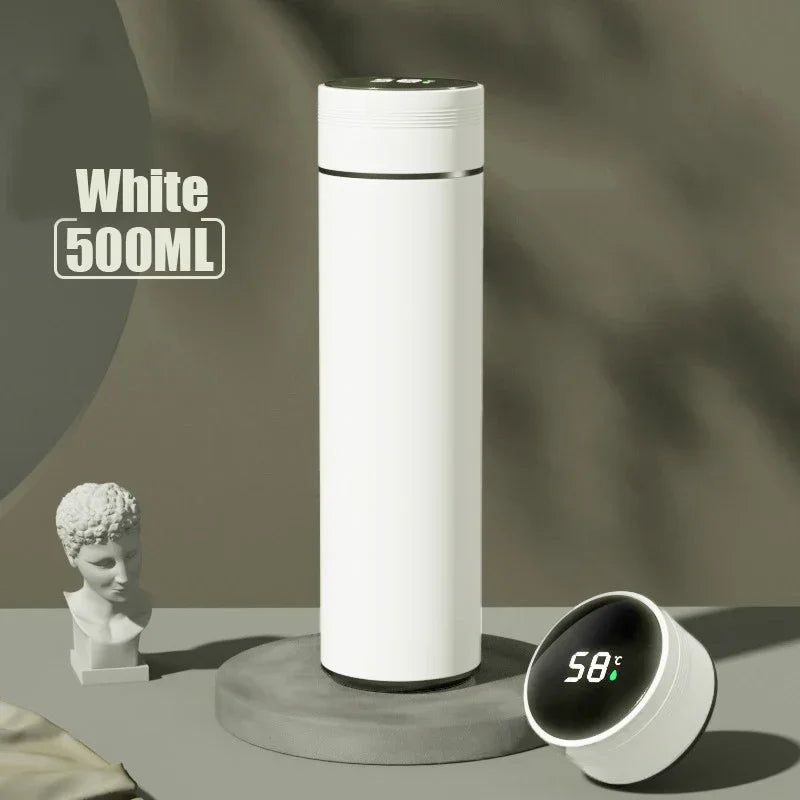 White 500ML thermos bottle with digital temperature display on a gray surface.