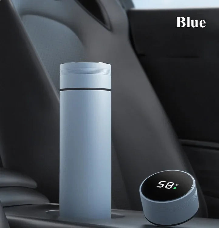Blue thermos bottle with digital temperature display on a car dashboard