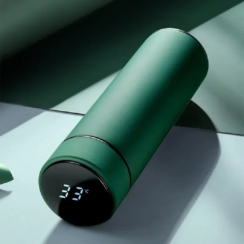 Green thermos with digital temperature display on a reflective surface