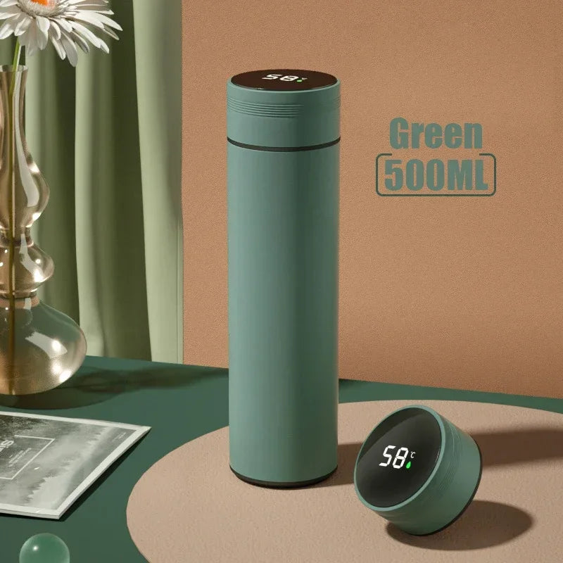Green thermos bottle with digital temperature display on a table with decorative items.
