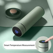 Smart temperature measurement device on a green surface with digital display